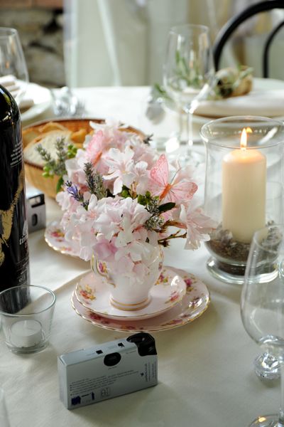  table centre pieces using the tea cups as the holders for the flowers