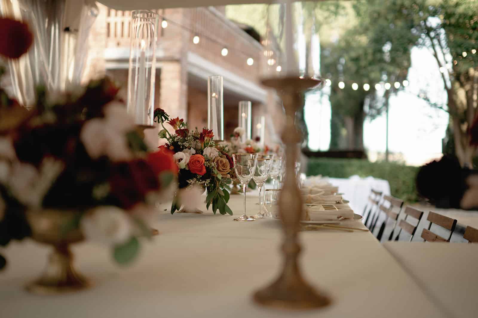 Wedding reception table with flowers and candles at Tenuta La Campana
